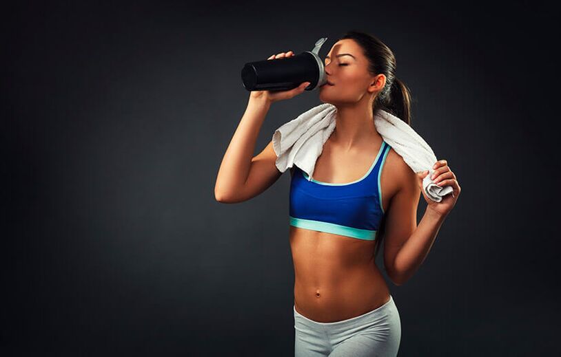 A woman in great shape uses a fat burning drink
